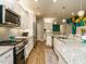 Dining area with a tropical leaf wall and decorative cabinet and featuring the quote 'Time together as a Gathering is a gift' at 67 Blue Spruce Cir, Clayton, NC 27527