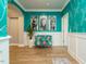Eclectic hallway featuring teal wallpaper, white wainscoting, colorful seating and Gathering photos at 67 Blue Spruce Cir, Clayton, NC 27527