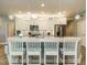 Bright kitchen with white cabinets, granite countertops, stainless steel appliances, and pendant lighting at 67 Blue Spruce Cir, Clayton, NC 27527