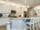 Spacious kitchen featuring granite countertops, stainless steel appliances, white cabinets, and pendant lights at 67 Blue Spruce Cir, Clayton, NC 27527