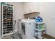 Functional laundry room equipped with washer, dryer, cabinets and a shoe rack at 67 Blue Spruce Cir, Clayton, NC 27527