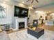 Open-concept living area with fireplace, modern decor, and seamless flow to the kitchen at 67 Blue Spruce Cir, Clayton, NC 27527