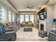 Spacious living room features fireplace, large windows with patterned curtains, and gray seating at 67 Blue Spruce Cir, Clayton, NC 27527