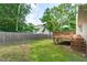 A view of the backyard, with a wood fence and a wooden deck at 700 Mossburn Ct, Fuquay Varina, NC 27526