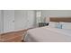 Comfortable bedroom with hardwood floors, a bedside table, and soft natural light at 700 Mossburn Ct, Fuquay Varina, NC 27526
