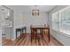 Bright dining room with modern lighting, light gray walls, and hardwood floors at 700 Mossburn Ct, Fuquay Varina, NC 27526