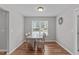 Cozy dining area with natural light, a simple table set, and wood flooring at 700 Mossburn Ct, Fuquay Varina, NC 27526