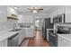 Well-equipped kitchen with white cabinets, stainless appliances, and wood-look flooring at 700 Mossburn Ct, Fuquay Varina, NC 27526