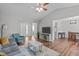 Open living area featuring hardwood floors, a ceiling fan, and seamless dining access at 700 Mossburn Ct, Fuquay Varina, NC 27526