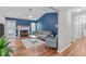 Stylish living room with blue accent wall, fireplace, and wood floors at 700 Mossburn Ct, Fuquay Varina, NC 27526