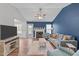 Bright living room featuring a fireplace, comfortable seating, and hardwood floors at 700 Mossburn Ct, Fuquay Varina, NC 27526