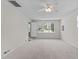 Inviting living room filled with light, featuring plush carpeting and large window views at 700 Mossburn Ct, Fuquay Varina, NC 27526