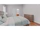 Cozy bedroom with a wooden bed frame, plush bedding, hardwood floors, and soft natural light at 700 Mossburn Ct, Fuquay Varina, NC 27526