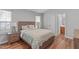 Comfortable bedroom featuring a wooden bed frame, bedside table, and light-filled windows at 700 Mossburn Ct, Fuquay Varina, NC 27526