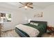 Bright bedroom with a ceiling fan, a large window, and a comfortable queen bed with stylish bedding at 7002 Longstreet Dr # C, Raleigh, NC 27615