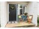Charming front porch with a cozy seating area and decorative potted flowers, creating a welcoming entrance at 7002 Longstreet Dr # C, Raleigh, NC 27615