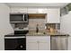 Modern kitchen featuring sleek appliances, stylish backsplash, and ample counter space at 7002 Longstreet Dr # C, Raleigh, NC 27615