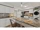 Contemporary kitchen showcasing granite countertops, modern appliances, and chic island seating at 7002 Longstreet Dr # C, Raleigh, NC 27615