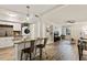 Open-concept living room with modern kitchen, sleek island seating, and an airy, inviting atmosphere at 7002 Longstreet Dr # C, Raleigh, NC 27615