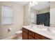 Well-lit bathroom with a double vanity, neutral walls, and a separate toilet room, creating a functional space at 733 Bluffcreek Dr, Fuquay Varina, NC 27526