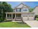 Charming two-story home with a welcoming front porch and well-manicured lawn, a perfect curb appeal at 733 Bluffcreek Dr, Fuquay Varina, NC 27526
