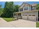 Beautifully landscaped two-story home featuring a covered front porch and an extended driveway leading to a two-car garage at 733 Bluffcreek Dr, Fuquay Varina, NC 27526