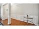 Bright foyer with hardwood floors, elegant wainscoting, and a glass-topped console table at 733 Bluffcreek Dr, Fuquay Varina, NC 27526