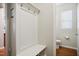 Hallway with a bench and storage leading into a half bathroom with neutral decor at 733 Bluffcreek Dr, Fuquay Varina, NC 27526