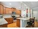 Spacious kitchen featuring granite countertops, stainless steel appliances, and a center island with barstool seating at 733 Bluffcreek Dr, Fuquay Varina, NC 27526