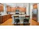 Well-equipped kitchen with stainless steel appliances, a center island with seating, and custom wood cabinetry at 733 Bluffcreek Dr, Fuquay Varina, NC 27526