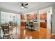 Open kitchen and dining area with wood cabinets, hardwood floors, granite countertops, and bar stool seating at 733 Bluffcreek Dr, Fuquay Varina, NC 27526