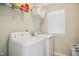 Efficient laundry room with modern appliances and shelving for organized storage at 733 Bluffcreek Dr, Fuquay Varina, NC 27526