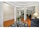 Open-concept living area with hardwood floors, white pillars, fireplace, and seamless flow to the kitchen at 733 Bluffcreek Dr, Fuquay Varina, NC 27526