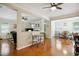 Bright and open-concept living space with wood floors, large windows, and a view of the dining area at 733 Bluffcreek Dr, Fuquay Varina, NC 27526