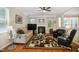 Comfortable living room with a fireplace, hardwood floors, ceiling fan, and ample seating space at 733 Bluffcreek Dr, Fuquay Varina, NC 27526