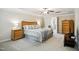 Relaxing main bedroom with tray ceilings, wood furnishings, and soft, neutral colors at 733 Bluffcreek Dr, Fuquay Varina, NC 27526