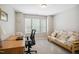 Well-lit office space with a large window, comfortable seating, and a functional desk, ideal for productivity at 733 Bluffcreek Dr, Fuquay Varina, NC 27526