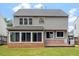 Large backyard with wooden deck, outdoor grill, and well-maintained lawn at 7414 Brandon Allen Ave, Raleigh, NC 27613