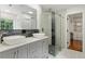 Modern bathroom with double sink vanity, stylish mirror, and walk-in shower at 7414 Brandon Allen Ave, Raleigh, NC 27613
