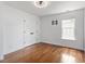 This bedroom has hardwood floors, a window, and double door closet at 7414 Brandon Allen Ave, Raleigh, NC 27613