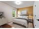 Staged bedroom features a bed, hardwood floors, and natural light at 7414 Brandon Allen Ave, Raleigh, NC 27613