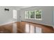 Empty bedroom with gleaming hardwood floors and abundant natural light at 7414 Brandon Allen Ave, Raleigh, NC 27613