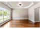 Spacious dining room with hardwood floors, neutral paint, crown molding, and a large window that offers plenty of natural light at 7414 Brandon Allen Ave, Raleigh, NC 27613