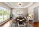 Stylishly staged dining room with hardwood floors, neutral walls, a modern chandelier, and ample space for entertaining guests at 7414 Brandon Allen Ave, Raleigh, NC 27613