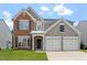 Charming two-story home featuring a combination of brick and siding facade with an attached two-car garage at 7414 Brandon Allen Ave, Raleigh, NC 27613