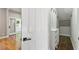 Inviting hallway features wood floors, white doors, and a convenient closet at 7414 Brandon Allen Ave, Raleigh, NC 27613