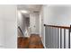 Upstairs hallway with hardwood floors and views of the stairwell at 7414 Brandon Allen Ave, Raleigh, NC 27613