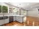 Modern kitchen flows into the living area, showcasing a large sink, stainless steel appliances, and hardwood floors at 7414 Brandon Allen Ave, Raleigh, NC 27613