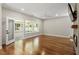Spacious living room with hardwood floors, a fireplace, and a glass door leading to a sunroom or patio at 7414 Brandon Allen Ave, Raleigh, NC 27613