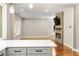 Open-concept living room and kitchen layout with hardwood floors, modern fireplace, and ample natural light at 7414 Brandon Allen Ave, Raleigh, NC 27613